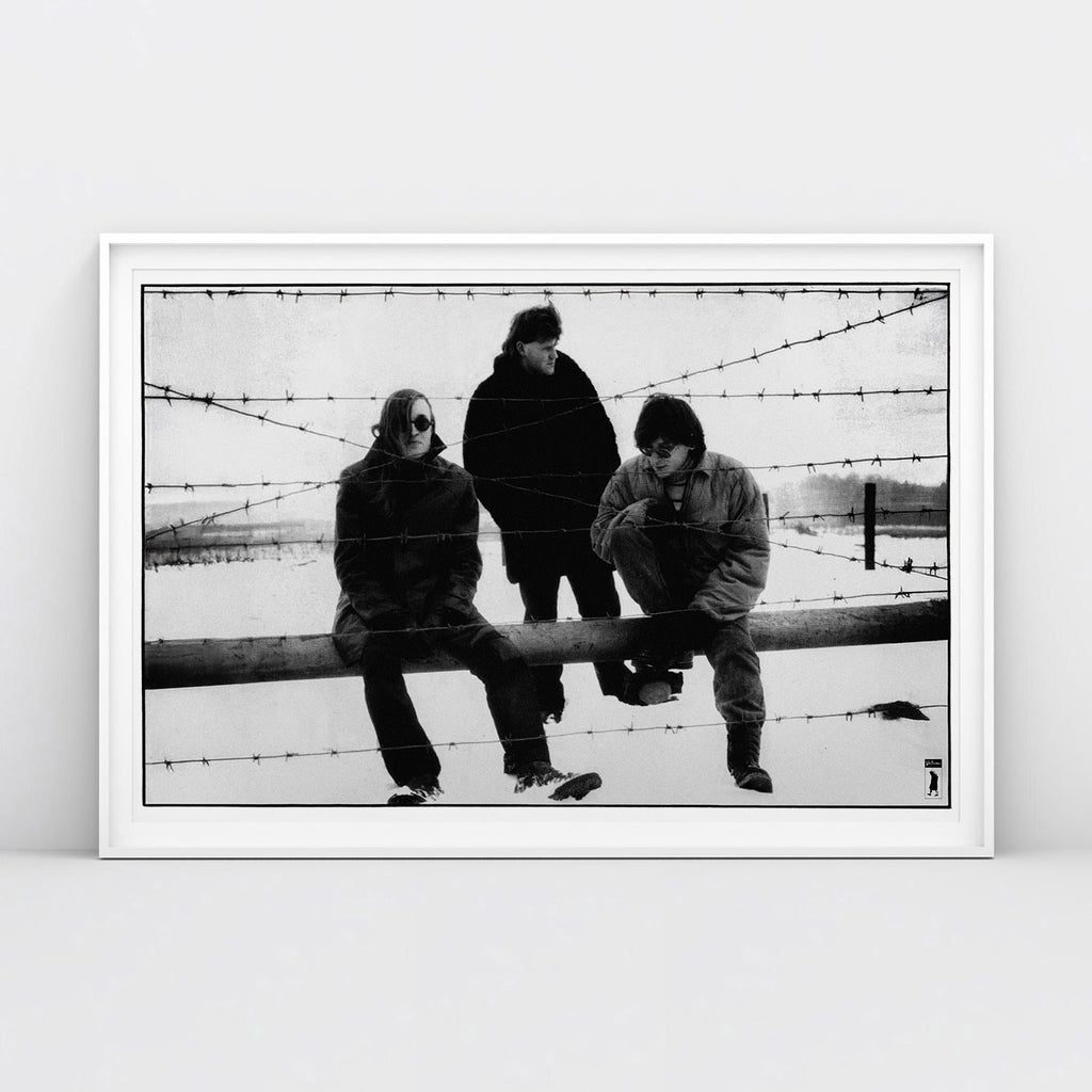 Large poster of Egor Letov and Grazhdanskaya Oborona band sitting in a snowy field behind barbed wire. www.egorletov.com
